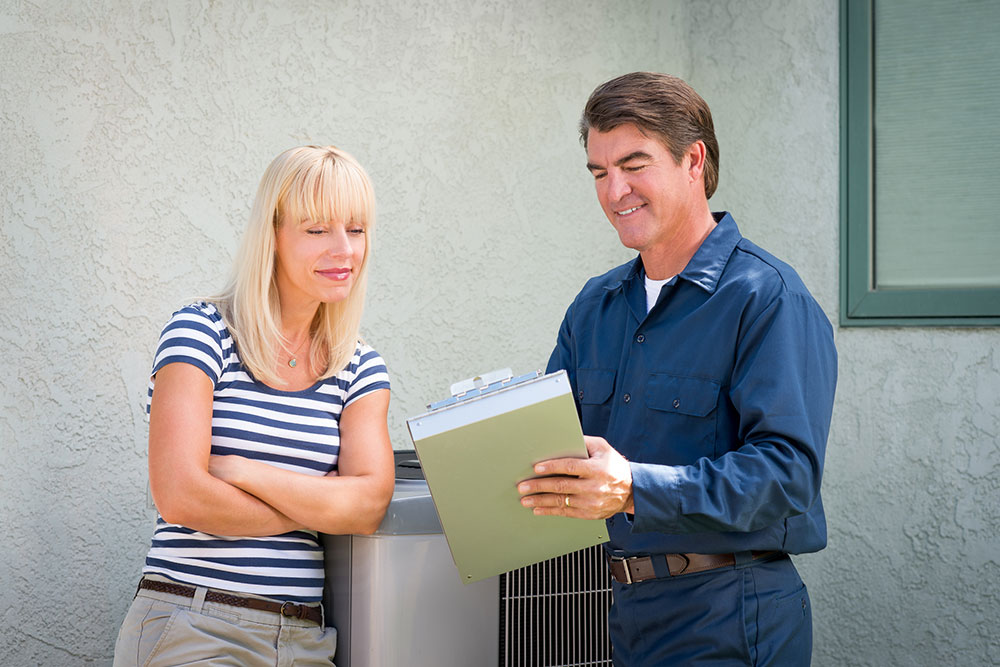 ac tech talking to woman