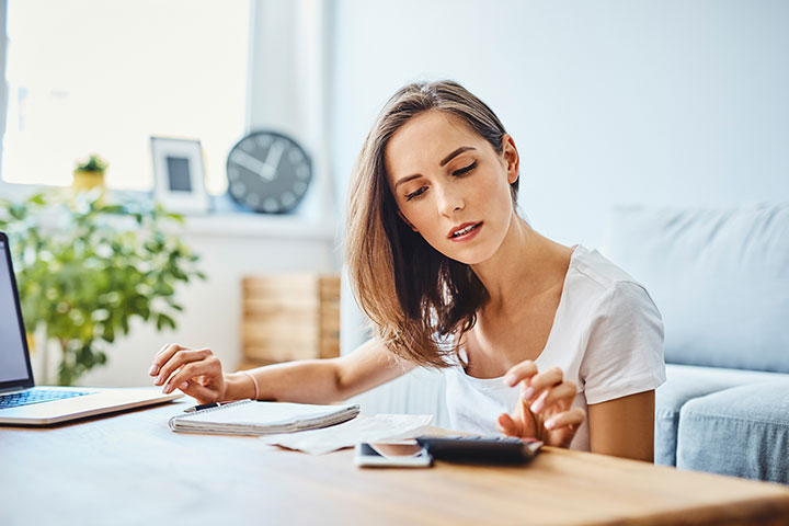 woman in her home calculating